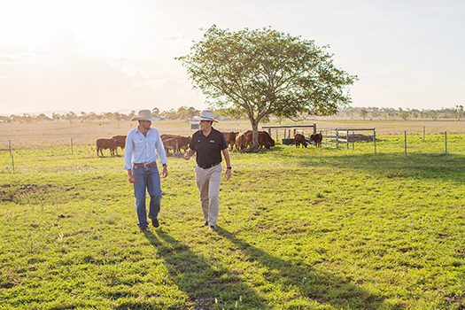 Producer walking on farm with QRIDA Regional Area Manager John Metelli