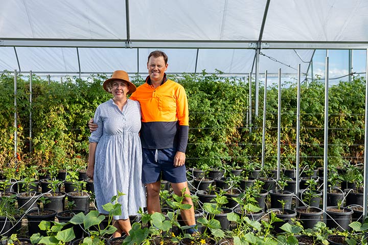 Jessica and Luke Volker standing in their greenhouse