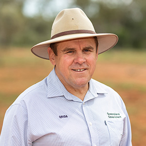 Regional Area Manager Terry Pulsford stands facing the camera, smiling, wearing a light coloured akubra hat and light blue business shirt