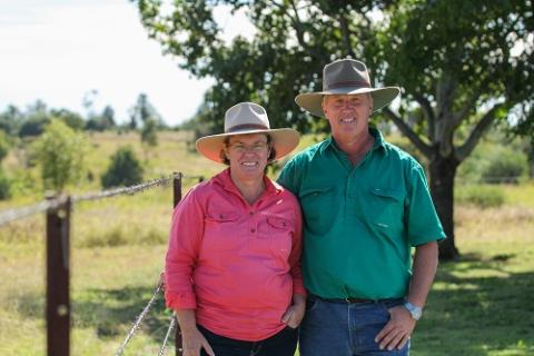 Women on left and man on right standing in a paddock